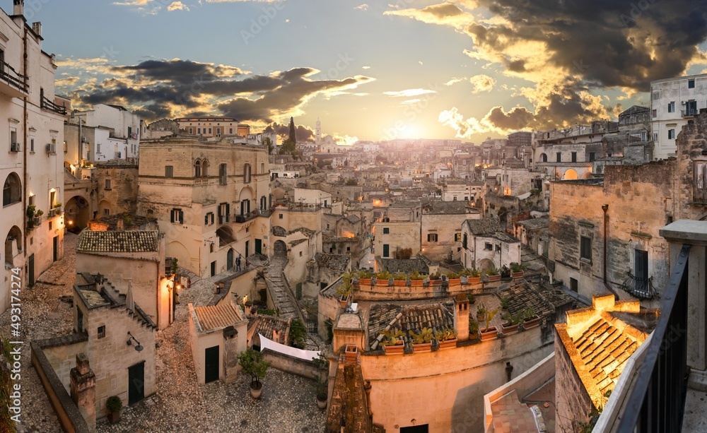 Matera, Basilicata, Italy.August 2021. Cityscape at blue hour with wide angle lens in the direction of the Sassi of Matera. Chaotic arrangement of the houses, in the background the cathedral.
