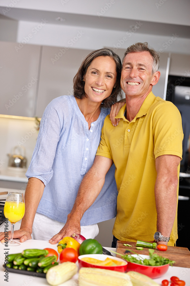 Healthy is the way to go. Portrait of a loving mature couple standing beside each other in the kitchen. Healthy is the way to go. Portrait of a loving mature couple standing beside each other in the kitchen.