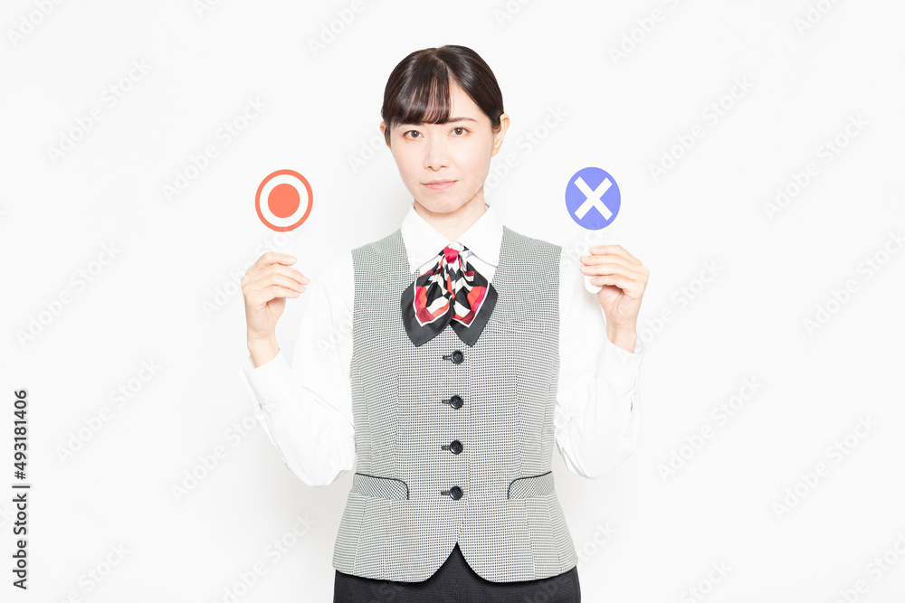白い背景の前に立ってOKとNGのプラカードを見せるビジネスウーマン