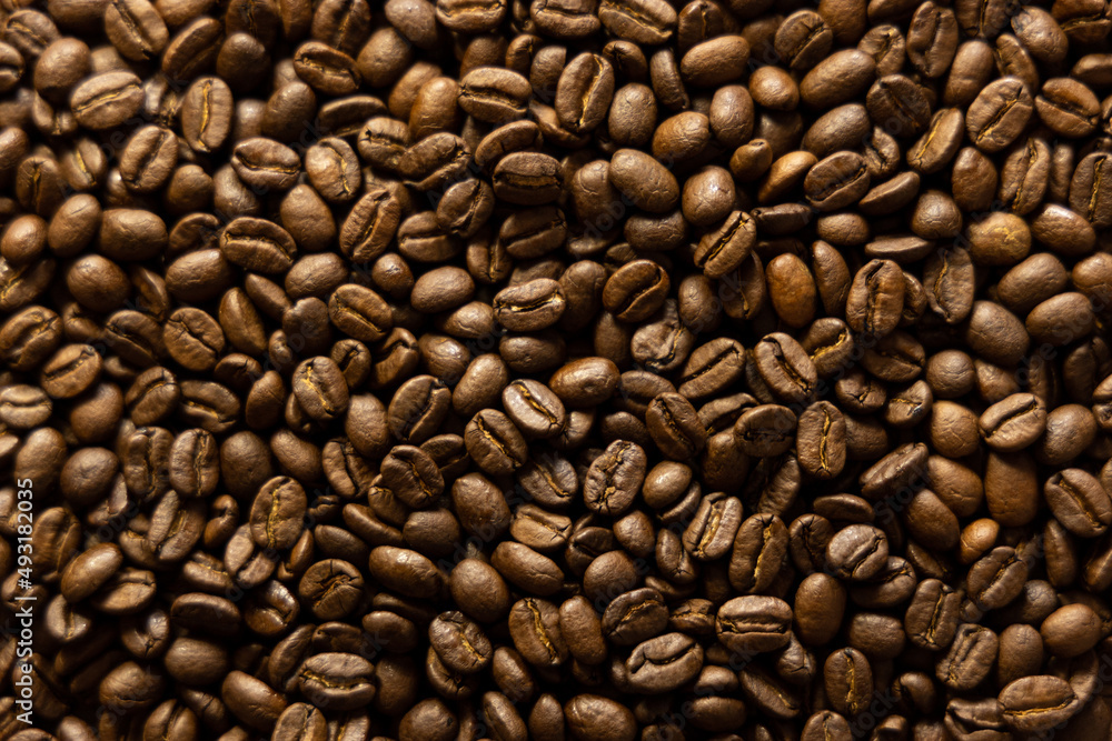 Fototapeta premium Background of roasted coffee beans. Top down view of full bean coffee