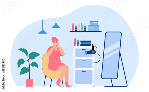 Woman sitting at mirror at skincare routine. Young cartoon girl moisturizing skin in bathroom flat vector illustration. Hygiene, morning routine concept for banner, website design or landing web page