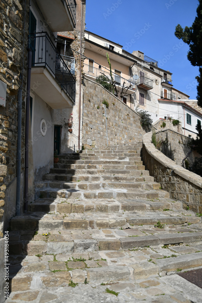 A narrow street among the old stone houses of Castellabate, town in Salerno province, Italy.	