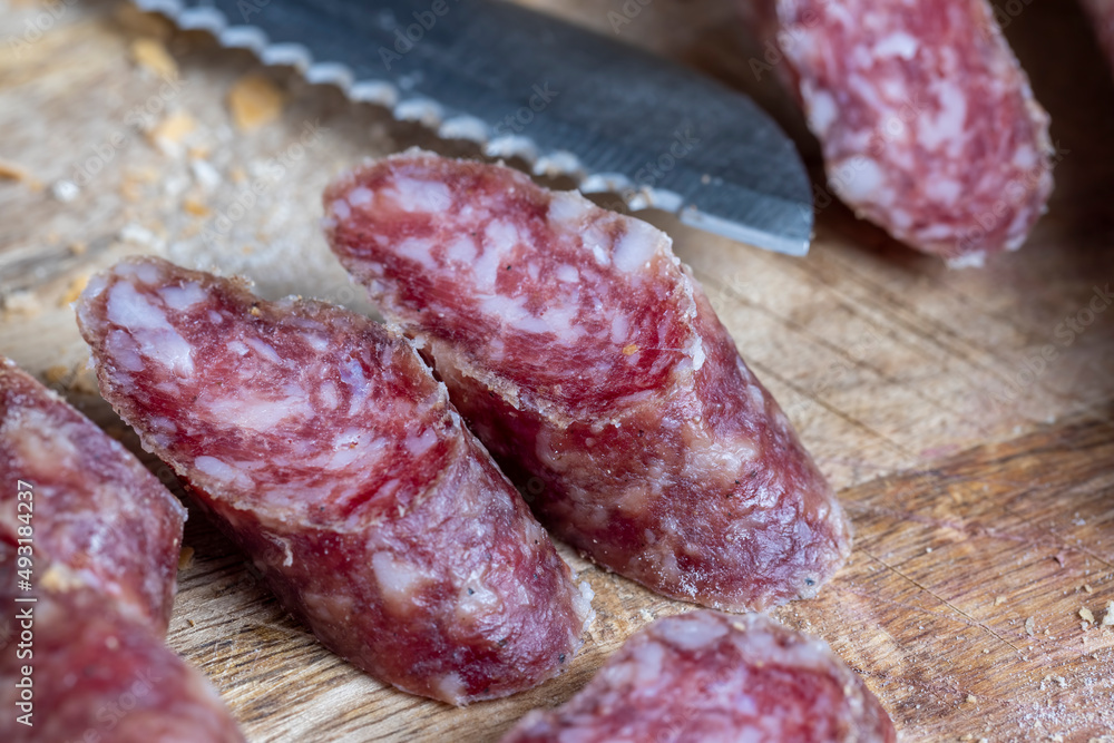 sliced pieces of sausage from meat are lying on a cutting board sliced pieces of sausage from meat are lying on a cutting board