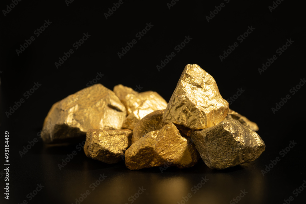 The pure gold ore found in the mine on black background The pure gold ore found in the mine on black background