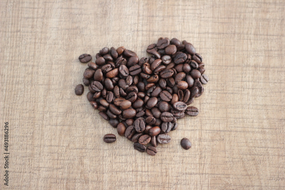 heart shaped coffee beans with wooden background heart shaped coffee beans with wooden background