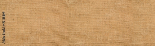 Cotton woven fabric background with flecks of varying colors of beige and brown. with copy space. office desk concept, Hessian sackcloth burlap woven texture background High Resolution ,panoramic