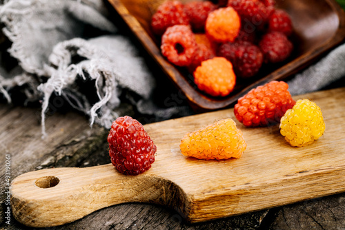 Fresh juicy raspberries in a wooden table. Summer still life with raspberries. A place to copy