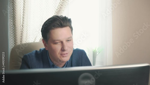 man making video call using computer