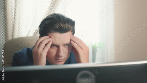 Depressed businessman at home behind computers