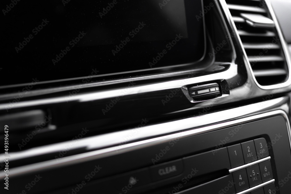 Modern car dashboard with multimedia screen. Interior detail, luxury vehicle close-up view background photo