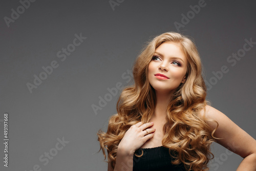 Surprised young woman smiling in studio smiling