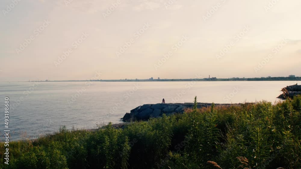 Person hanging out in front of Lake Ontario Person hanging out in front of Lake Ontario