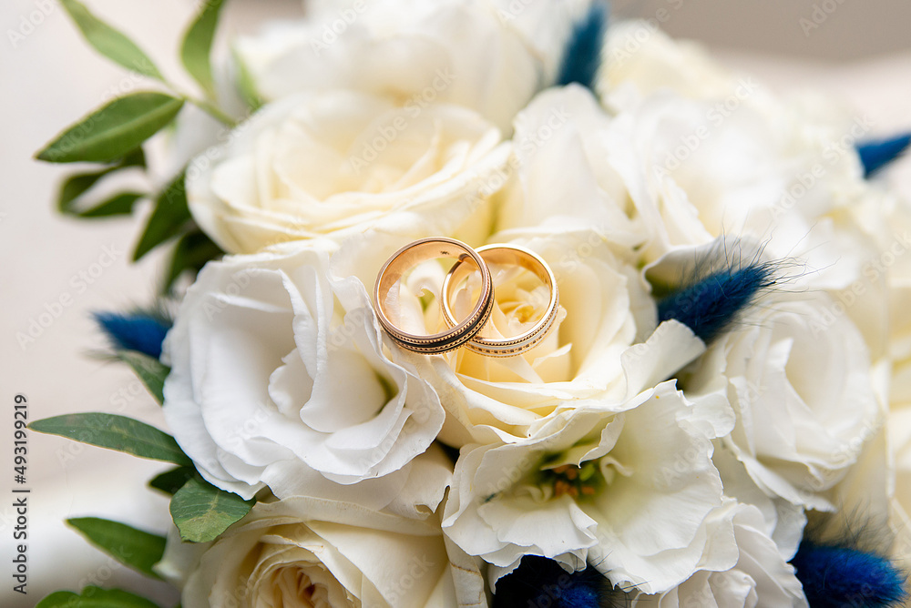 wedding gold rings on the background of a bouquet wedding gold rings on the background of a bouquet