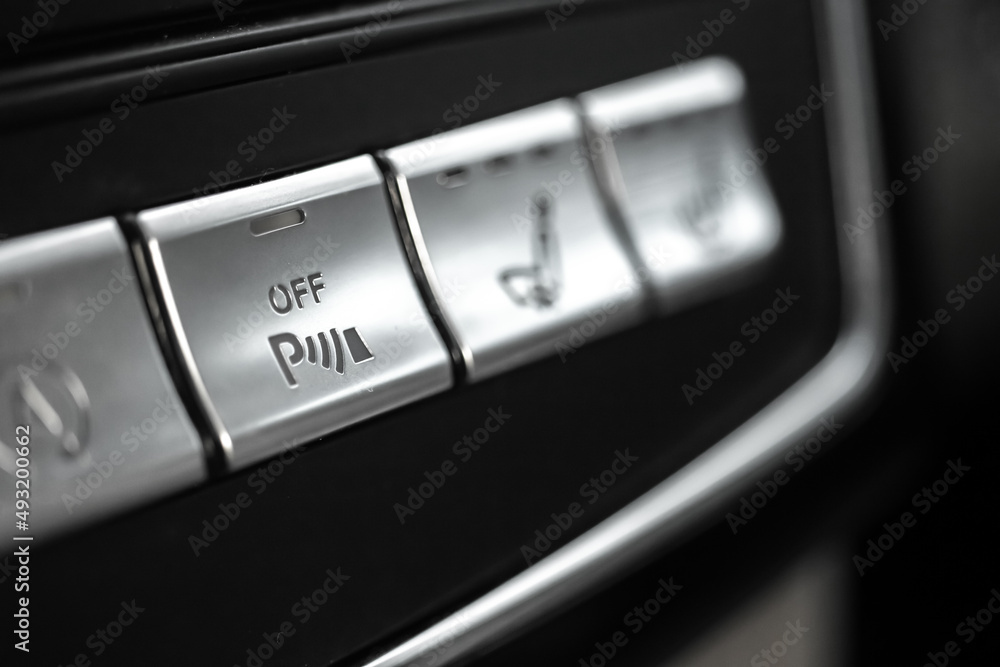 Car parking assist button inside luxury car interior close-up view photo