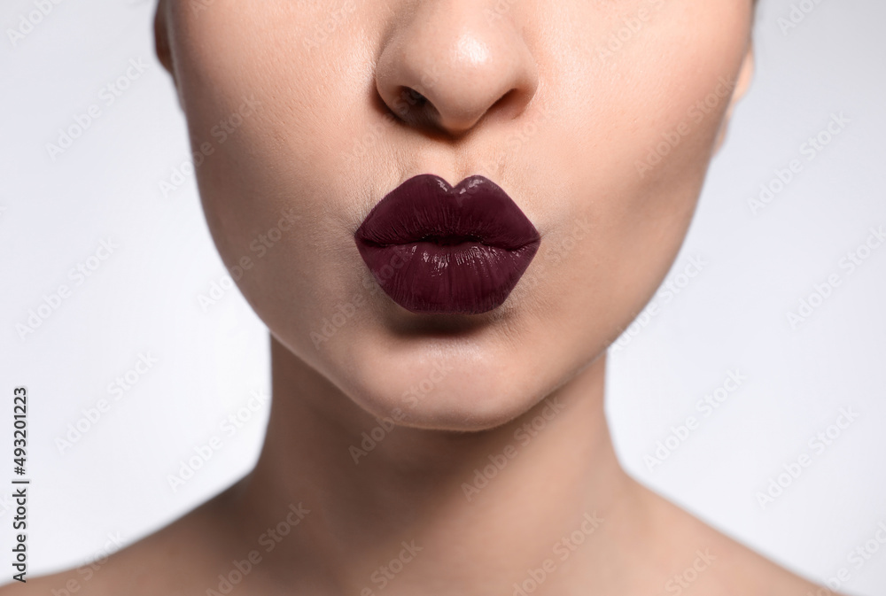 Young woman with beautiful lips makeup on light background, closeup Young woman with beautiful lips makeup on light background, closeup