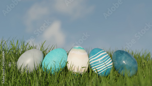 Easter Eggs In Green Grass on a Blue Sky  3d rendering