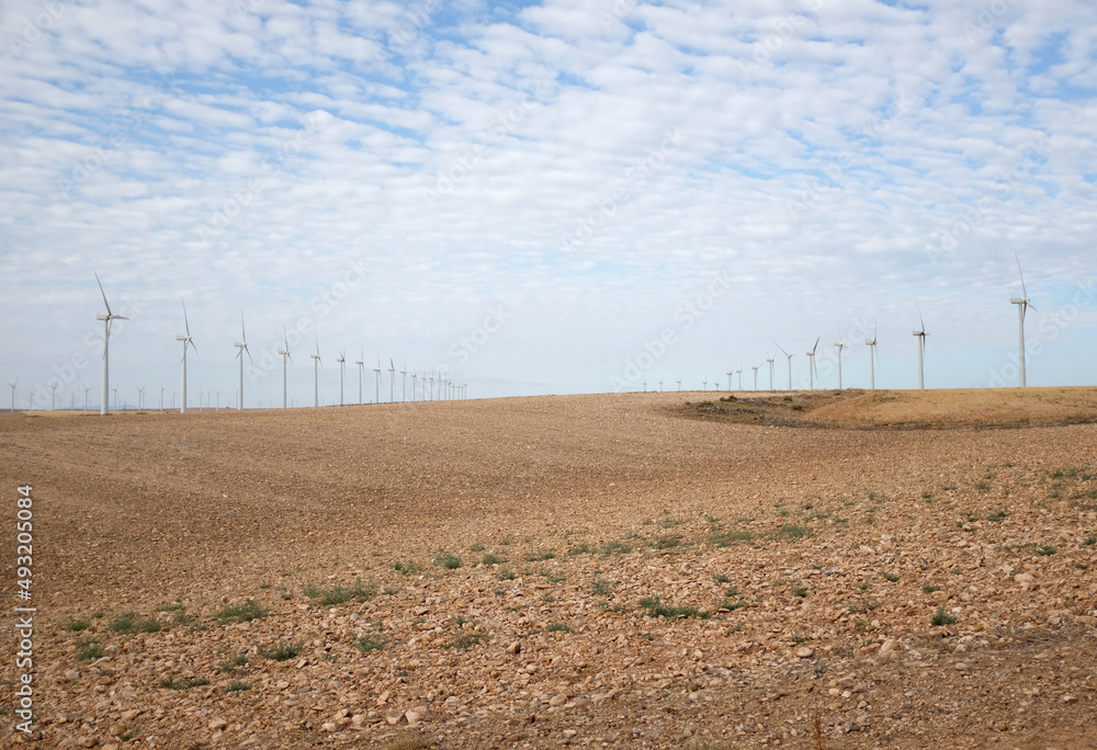 Wind farm in dry farmland. Alternative energy to the fossil fuel crisis Wind farm in dry farmland. Alternative energy to the fossil fuel crisis
