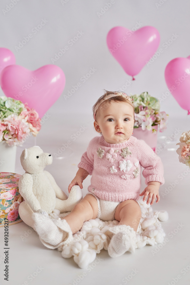 Fototapeta premium Valentine Baby girl. Valentine's Day. Balls and flowers. Celebration. Mother's day postcard. International day of happiness. Birthday party
