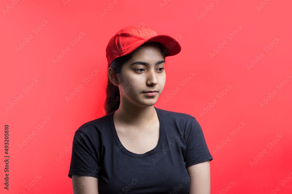 Confident young delivery woman standing isolated on Color Background Confident young delivery woman standing isolated on Color Background