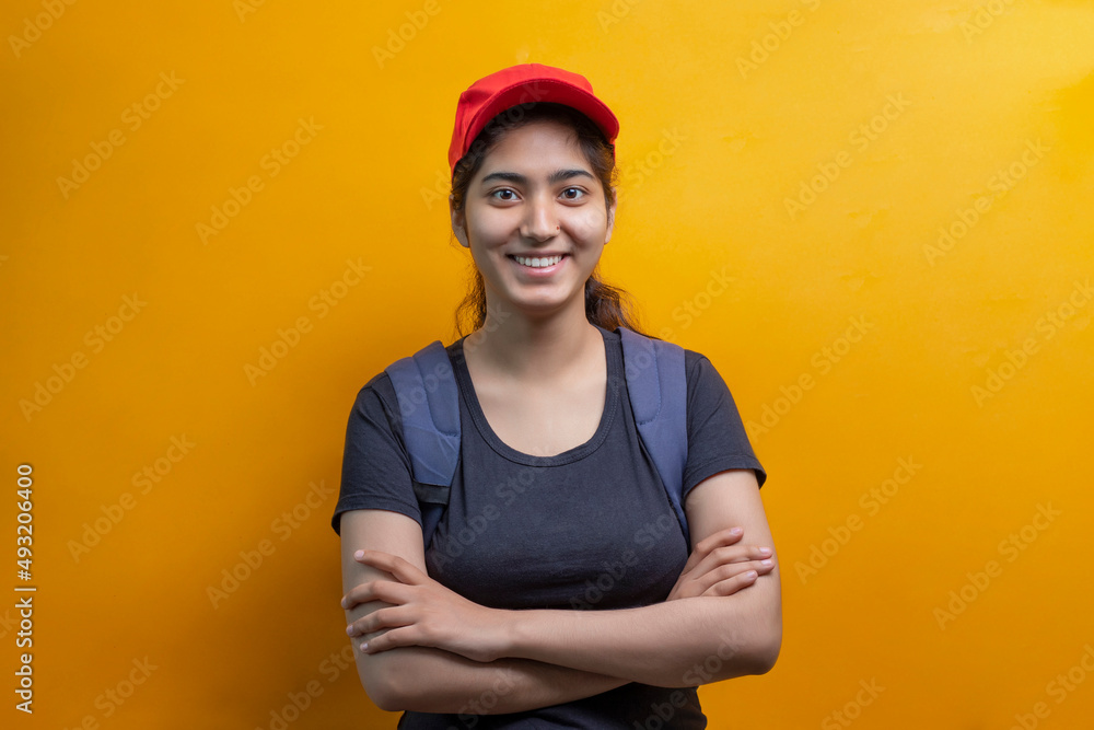 PORTRAIT OF A Delivery Woman STANDING WITH BAG LOOKING HAPPILY AT CAMERA