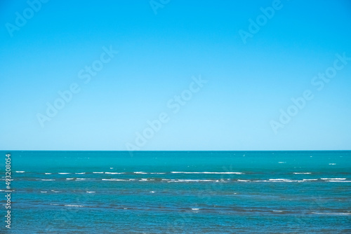 Beautiful lake with waves and clear blue sky. Wind on Balkhash lake. Travel, tourism in Kazakhstan concept. Natural seascape.