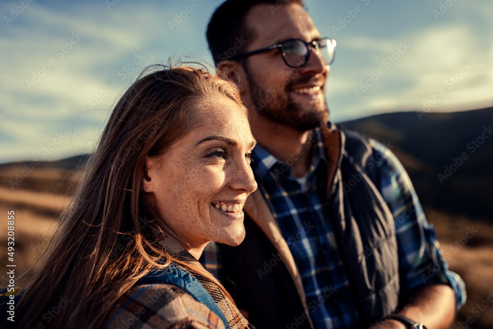 Couple with backpacks hiking together in nature. Couple with backpacks hiking together in nature.