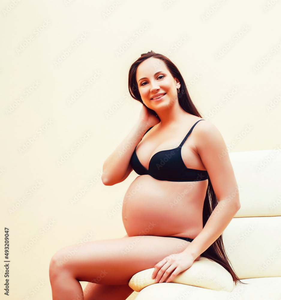 Obraz premium young brunette woman at home in chair pregnant, lifestyle people concept