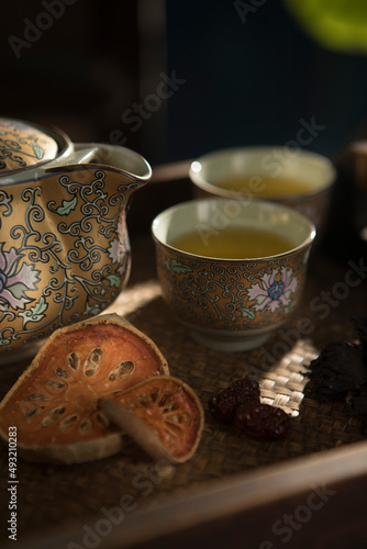 Close up view of nice china teapot and glasses on color back