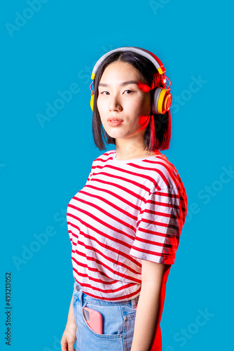 young asiatic woman isolated listening music