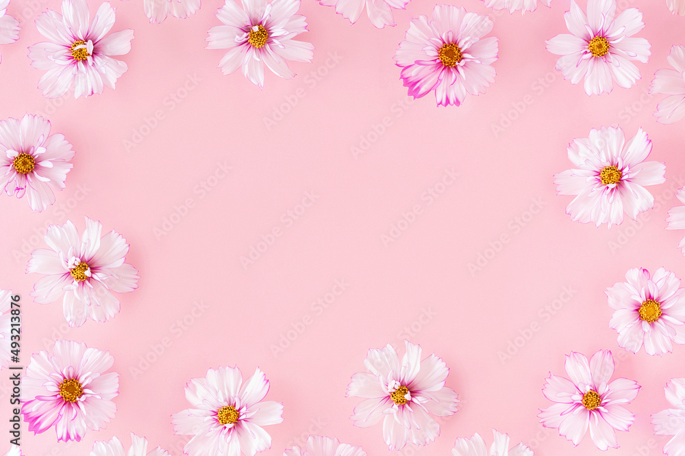 Frame made with flowers on pink background. Flat Lay Top view Copy space