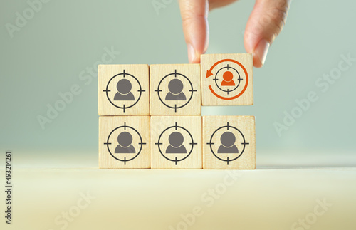 Digital marketing, retargeting or remarketing concept. Online strategies in social media, website visitor management and solution for marketing campaigns. Puttiing wooden cubes with retargeting icon. photo