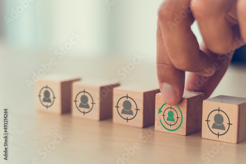 Digital marketing, retargeting or remarketing concept. Online strategies in social media, website visitor management and solution for marketing campaigns. Puttiing wooden cubes with retargeting icon. photo