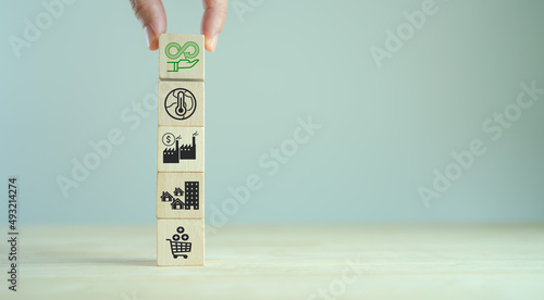 Circular economy concept. Business and environment sustainable. Climate changing problem solving goals..Stacking wooden cubes with sustainability icon on pollution sources icon with grey background.