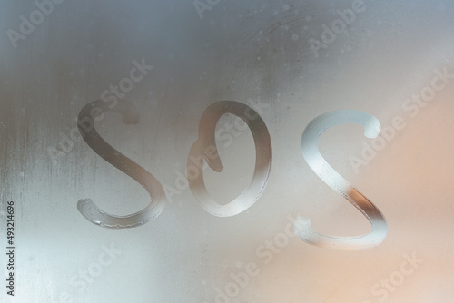 The inscription SOS on the glass fogged up. Call for help.