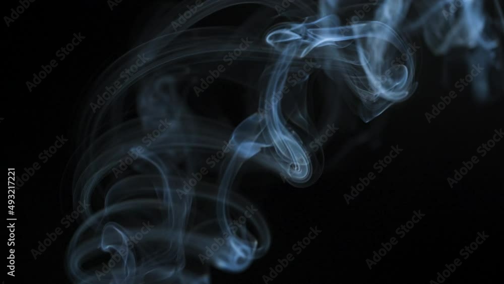 Abstract smoke rises up in beautiful swirls on a black background Abstract smoke rises up in beautiful swirls on a black background