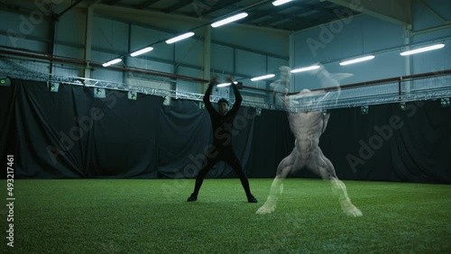 Actor in motion capture suit performing some stunt moves next to a game character. Motion capture is an unparalleled method for making animated characters move more realistically photo