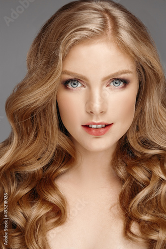 Stunning natural beauty with blonde wavy hair.