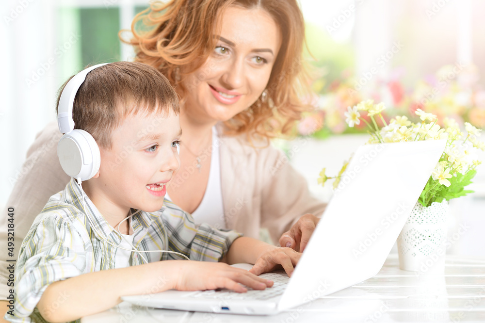 mother and son using modern laptop mother and son using modern laptop