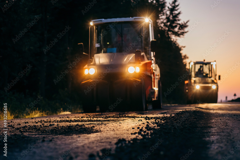 Vibratory asphalt roller compactor compacting new asphalt pavement. Road service repairs the highway Vibratory asphalt roller compactor compacting new asphalt pavement. Road service repairs the highway