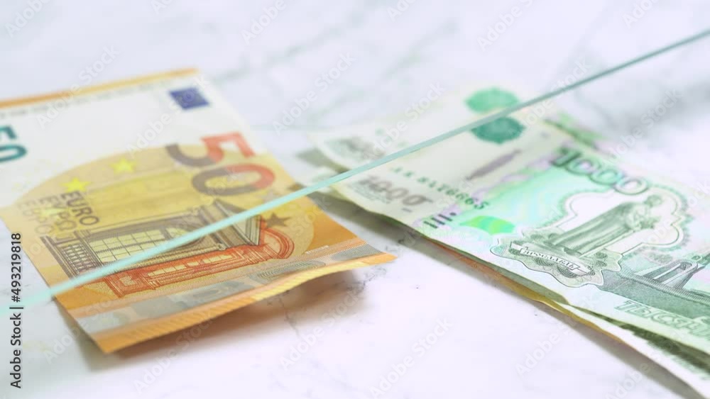 Person exchange money to teller at cash department window, closeup. Exchange euro notes to rubles in bank. Sanctions in Russia, high exchange rate. Person exchange money to teller at cash department window, closeup. Exchange euro notes to rubles in bank. Sanctions in Russia, high exchange rate.