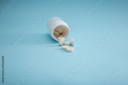 Medical packaging of pills on a blue background, a cure for the disease