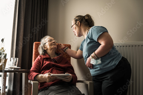 Family portrait of a 83 year old mother and her daughter with Down Syndrome at home
