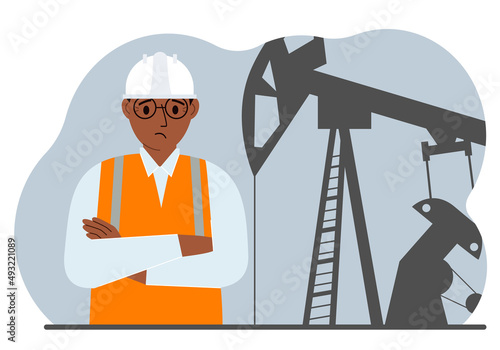 Oil refinery engineer. A male worker in front of a pumping unit for oil extraction, oil drilling and well repair.