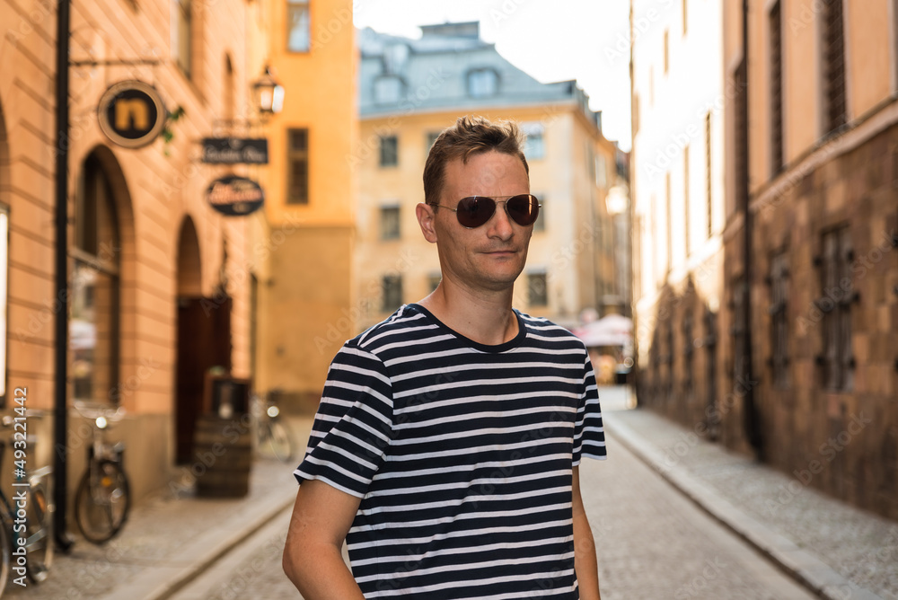 Stockholm, Sweden - Handsome fourty year old man with striped t-shirt posing for a self-portrait in Gamla Stan, Old Town