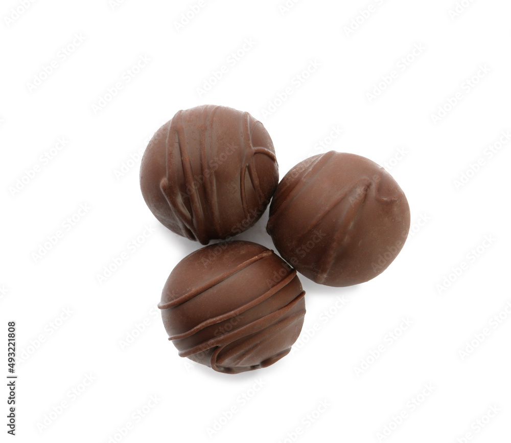 Fototapeta premium Delicious sweet chocolate truffles on white background, top view