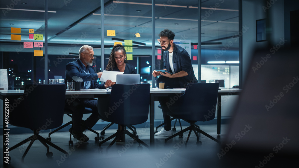 Office Conference Room Meeting: Diverse Team of Top Managers Talk, Brainstorm, Use Laptop Computer. Business Partners Discuss Financial Reports, Plan Investment Strategy and Managerial Operations.