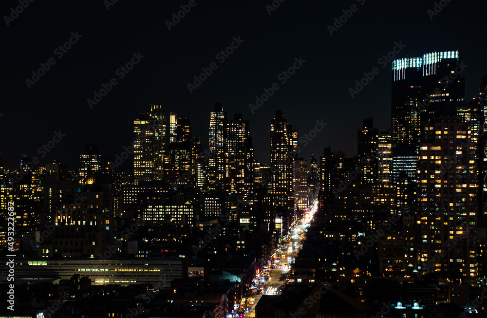 A shot of Manhattan New York citiscape skyline at night. The shot was taken on 42nd St looking into the skyscrapers lit up with their internal lights A shot of Manhattan New York citiscape skyline at night. The shot was taken on 42nd St looking into the skyscrapers lit up with their internal lights