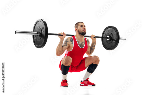 Close-up strong man red sportswear raising barbell up isolated on white background. Sport, weightlifting, power, achievements concept