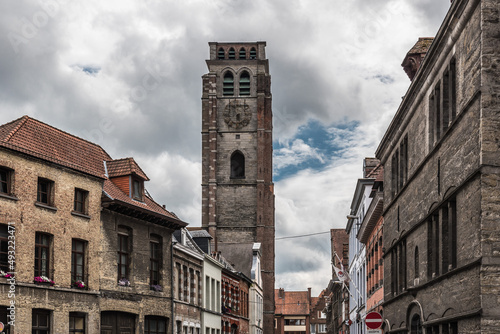 Tournai Doornik, Walloon Region  Belgium -  Facades of residential and commercial buildings in old town with the tower of the Saint Brice church photo