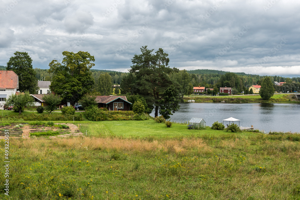 View over the Swedish countryside around Segersta with Agricultural fields, trees, grass and a pond View over the Swedish countryside around Segersta with Agricultural fields, trees, grass and a pond